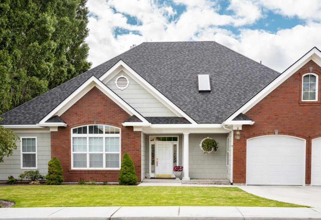 Beautiful brick and siding single-story home with covered porch and attached garage