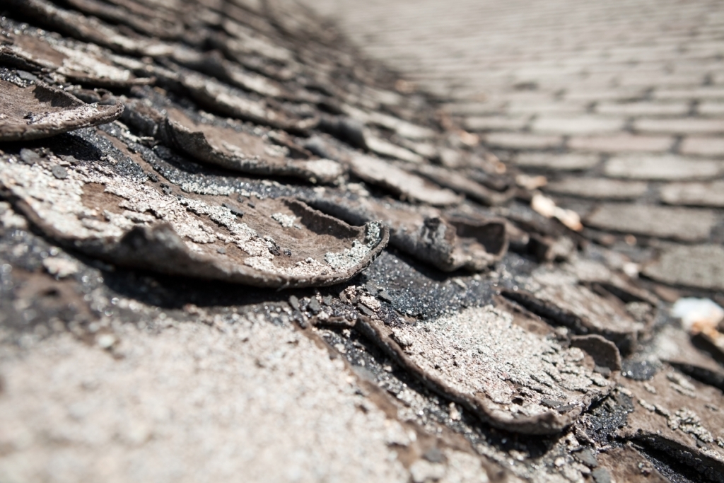 Weathered wooden roof shingles showing age and deterioration with natural patina