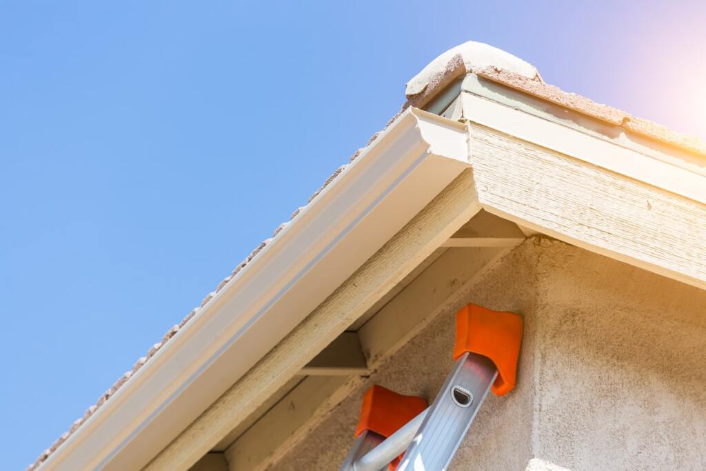 Ladder beside house gutter installation
