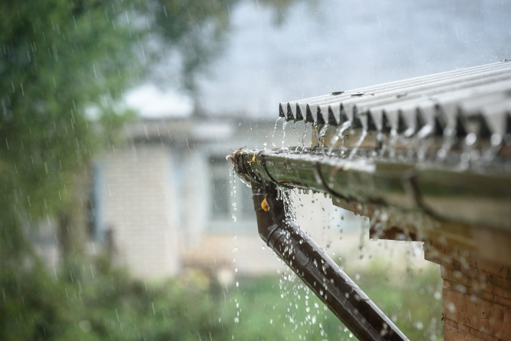 Rainwater flowing from roof gutter